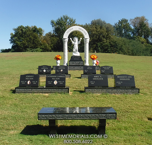 nelson family headstone monument with jesus statue and black granite bench